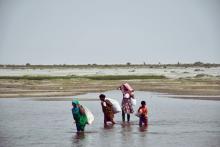 People crossing a river in Bangladesh