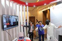 Prof Sun Dong, Secretary for Innovation, Technology and Industry (middle), visits Lingnan’s booth to learn about the AI-based Fencing Training and Assessment System, a project introduced by Prof Sam Kwong Tak-wu (left). 