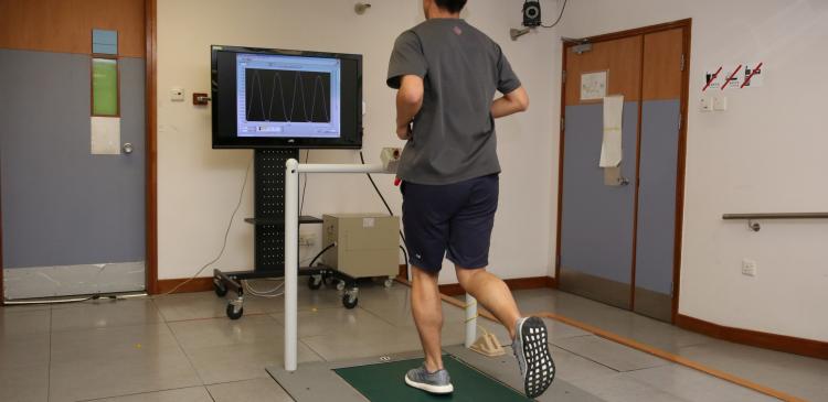 A runner receives visual biofeedback from the monitor during gait retraining.