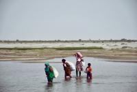 People crossing a river in Bangladesh