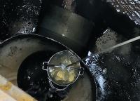 Wastewater sample being collected from a manhole in the village (Photo: Masaaki Kitajima).