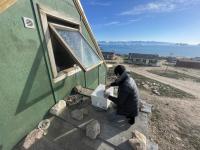 Tomoki Kajikawa, co-author of the study, installing the PM2.5 measurement system at the site in Qaanaaq (Photo provided by Tomoki Kajikawa)